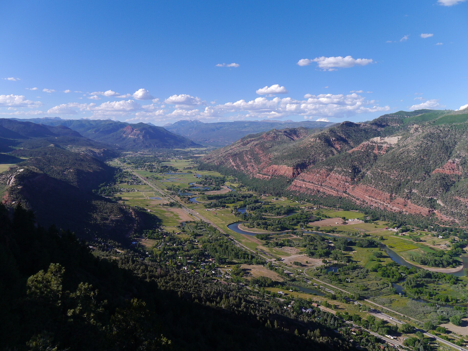 Summer view over the green Animas Valley near Durango, Colorado, with red-rock ridges and distant San Juan peaks